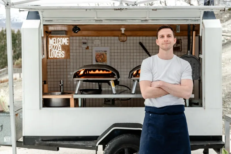 Biga Pizza wood-fired trailer with ovens and Welcome Pizza Lovers sign